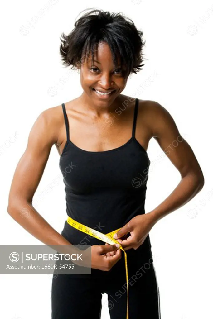 Woman measuring waist with tape measure