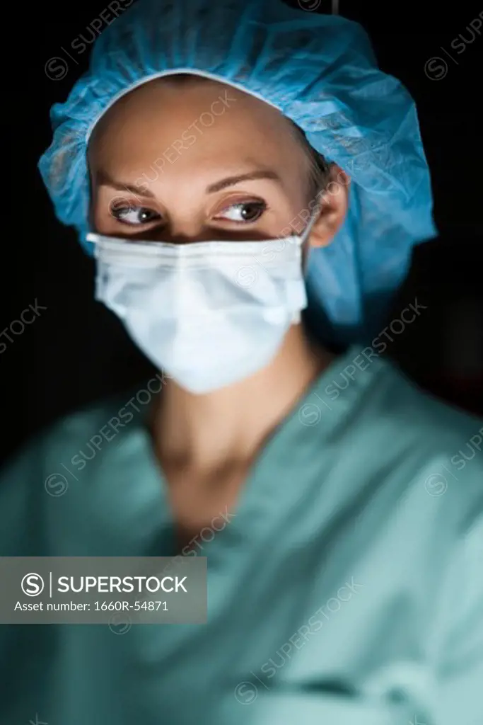 Woman in surgical scrubs looking up