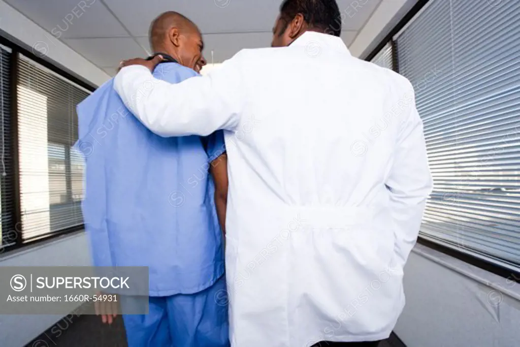 Male doctor and hospital worker talking