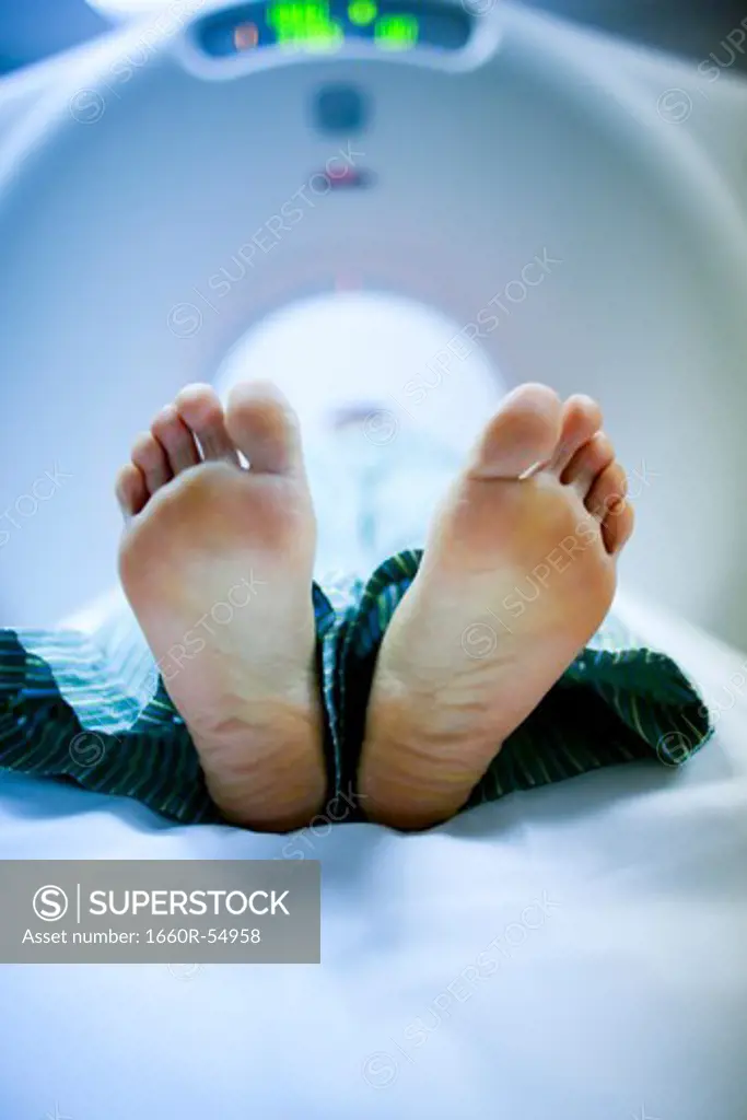 Closeup of woman's feet on diagnostic bed