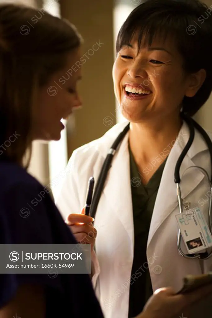 Female doctor smiling at nurse
