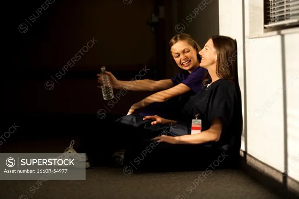 Two nurses sitting and talking