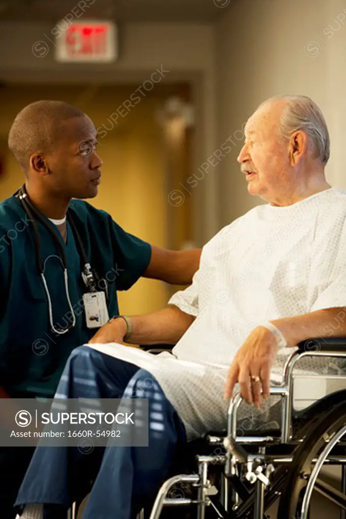 Mature man in wheelchair with doctor and nurse
