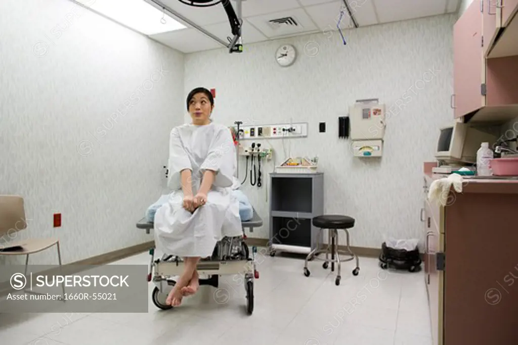 Female patient waiting anxiously in examining room