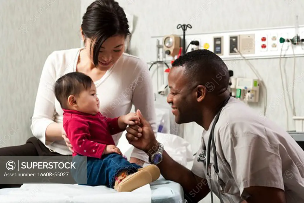 Mother and baby in examining room with doctor
