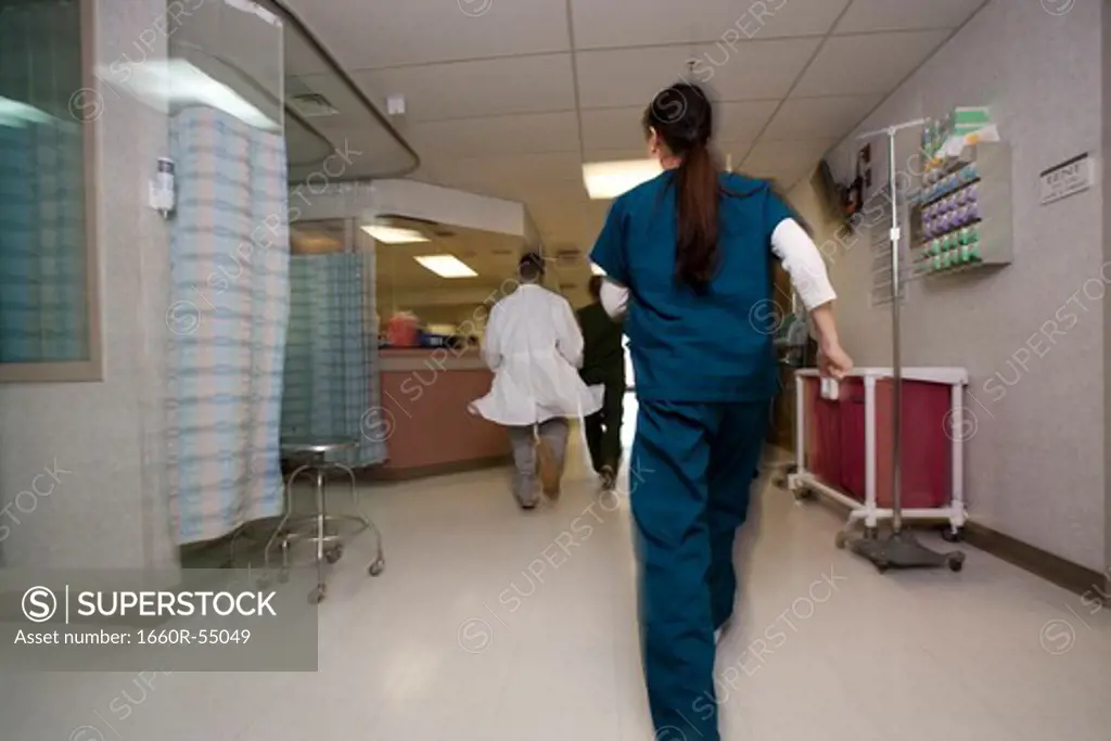 Doctor and nurses rushing through corridor