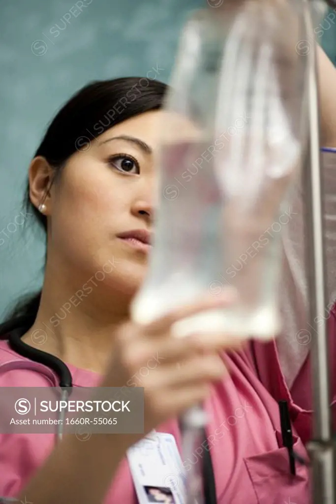Closeup of nurse adjusting IV bag