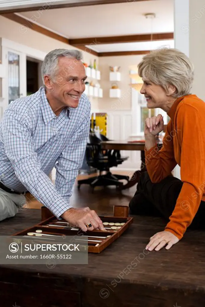 Mature couple playing backgammon