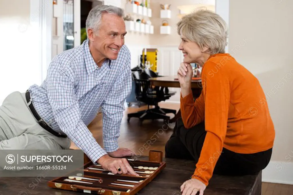 Mature couple playing backgammon