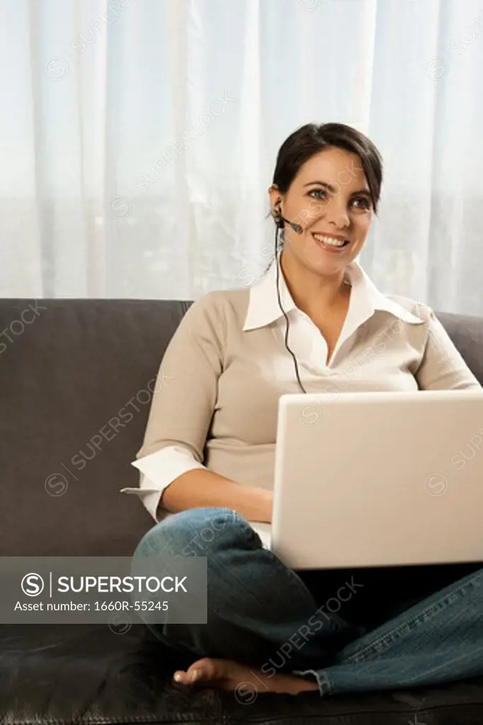 Woman on sofa with laptop