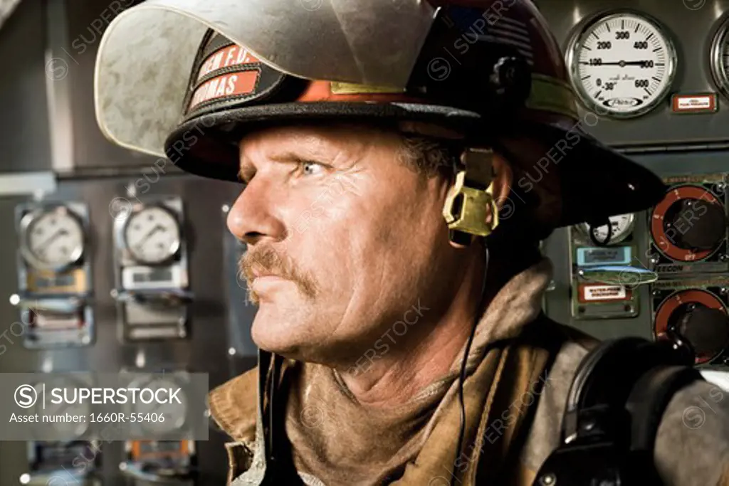 Portrait of a firefighter in front of control panel