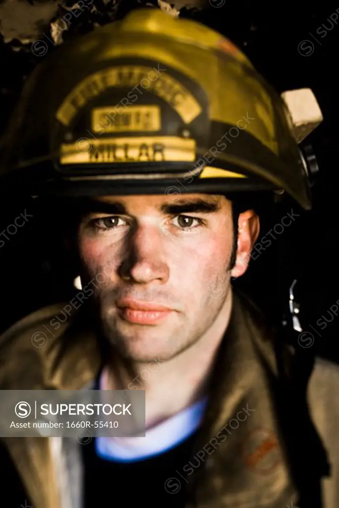 Portrait of a firefighter with fire hose