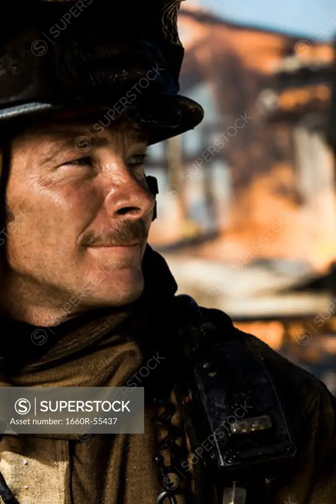 Portrait of a firefighter with fire in background
