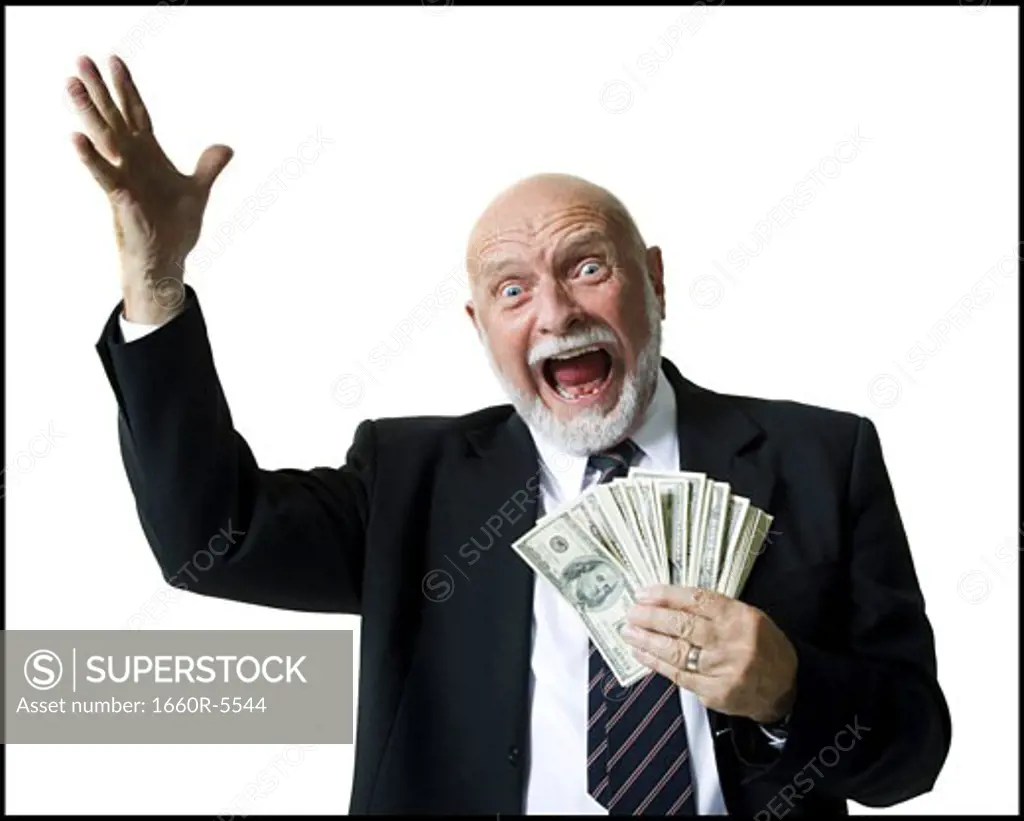 Portrait of a businessman holding one hundred dollar bills