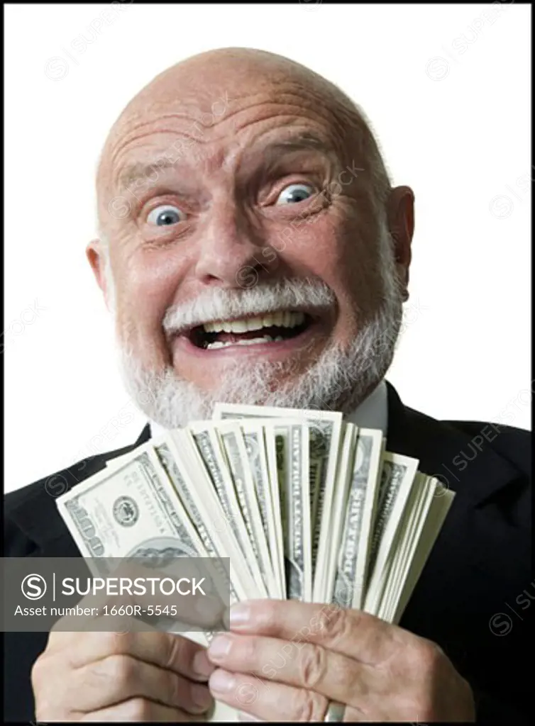 Portrait of a businessman holding one hundred dollar bills