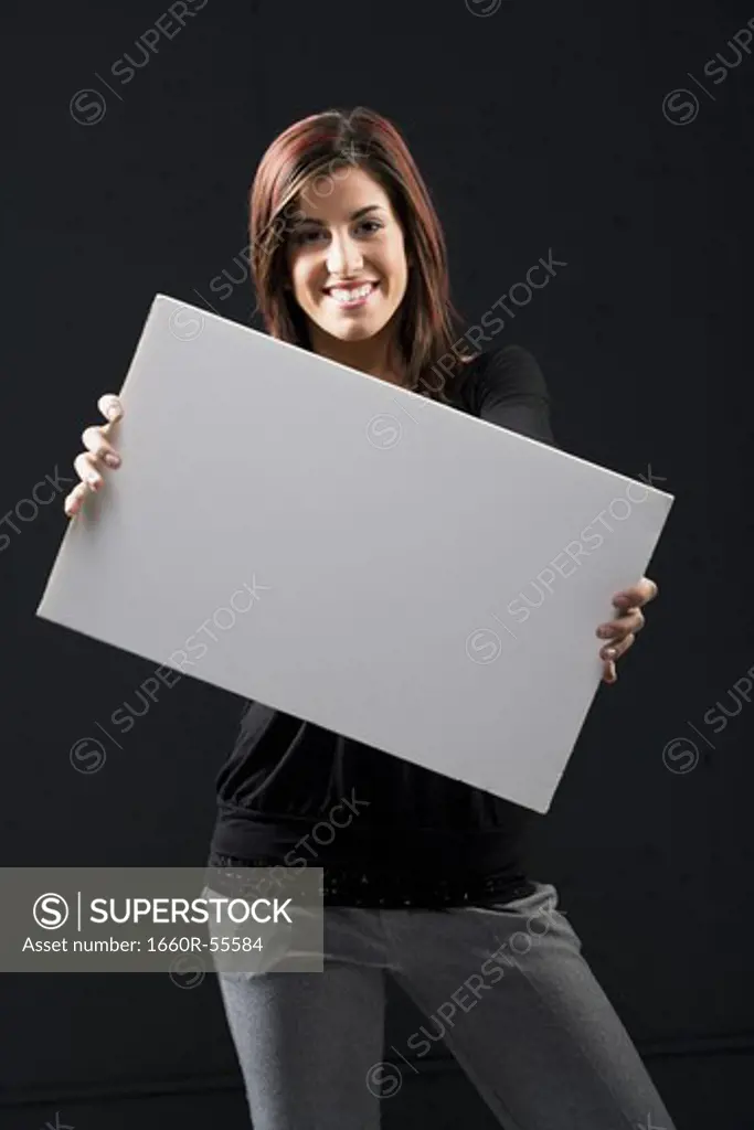 Woman standing with blank sign