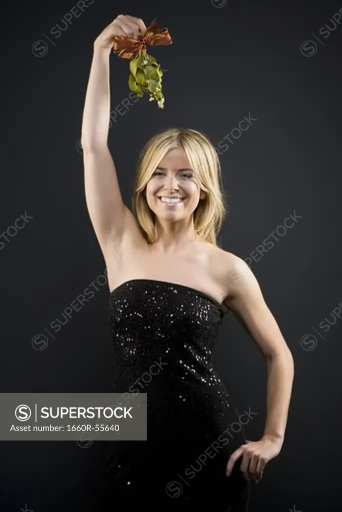 Woman holding mistletoe