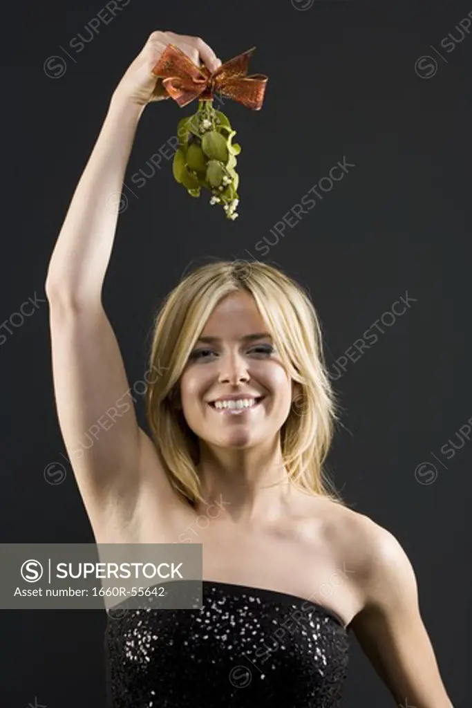 Woman holding mistletoe