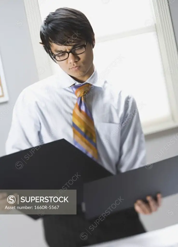 Businessman comparing two presentation boards