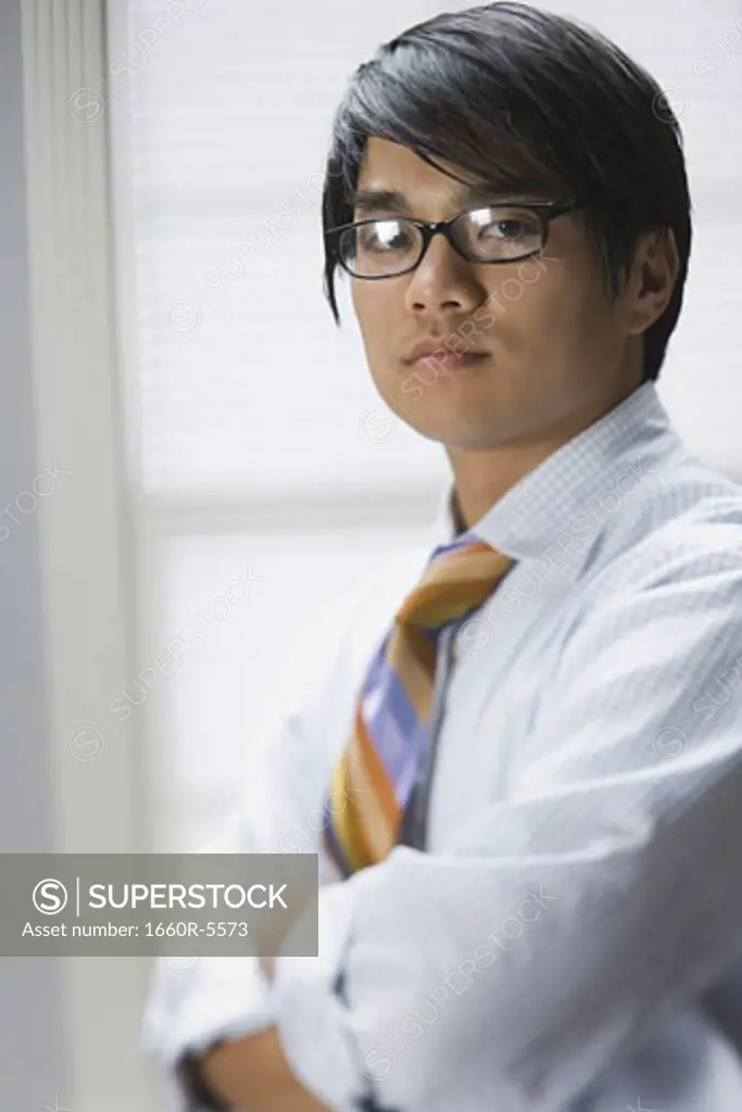 Portrait of a businessman standing with his arms folded