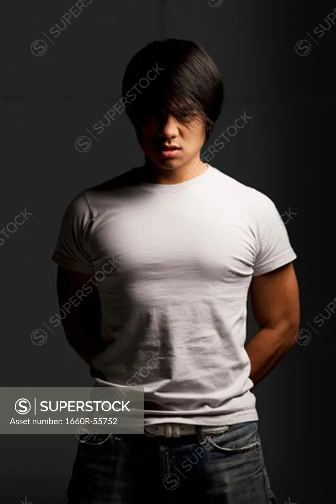 Muscular man with tensed arm looking hostile