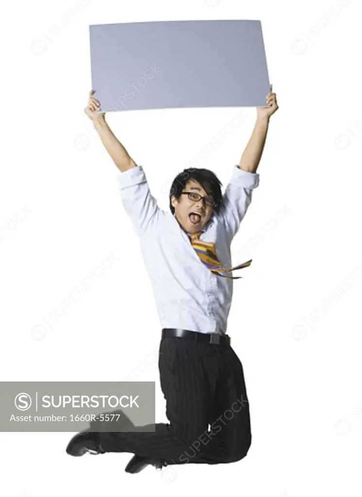 Portrait of a businessman holding a blank sign and jumping
