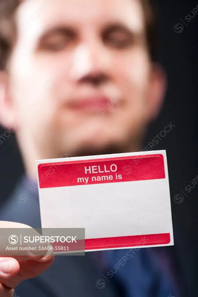 Man holding blank name tag