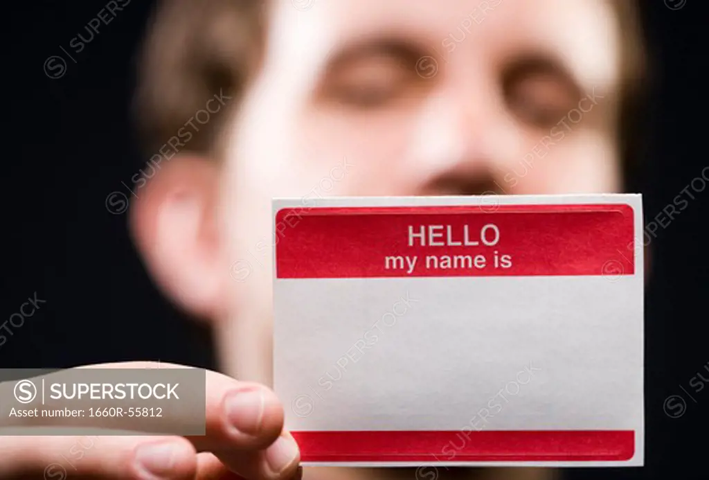 Man holding blank name tag