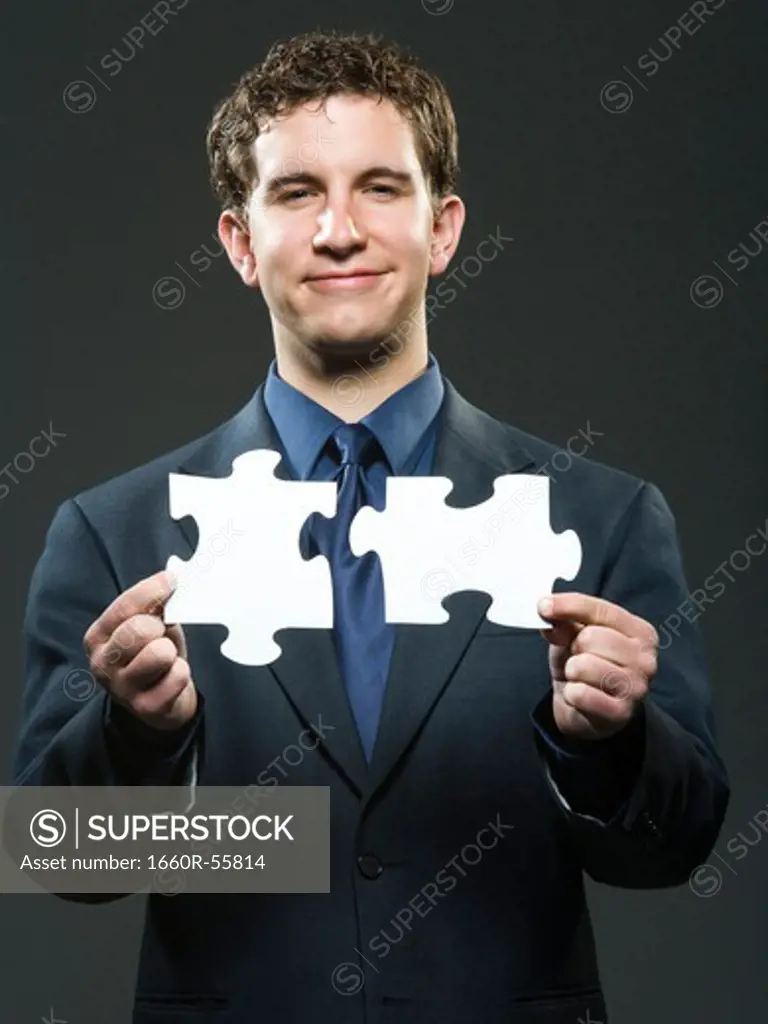 Businessman holding blank sign smiling