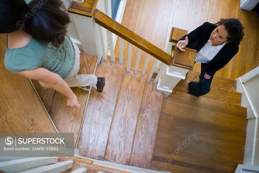Two women arguing on staircase