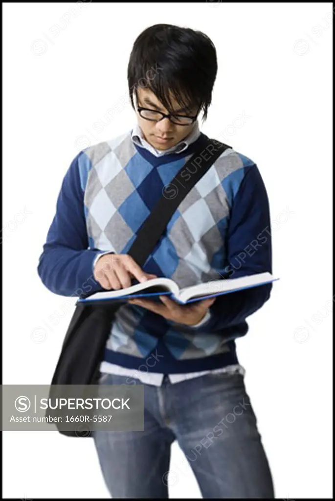 Young man reading a textbook