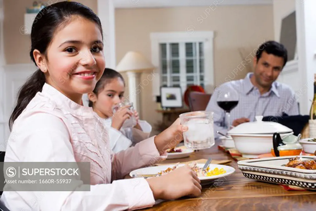 Girls at dinner table eating