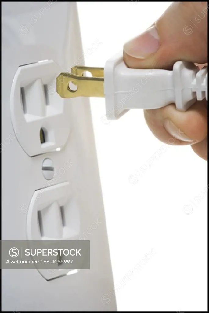 Detailed view of prongs and wall socket