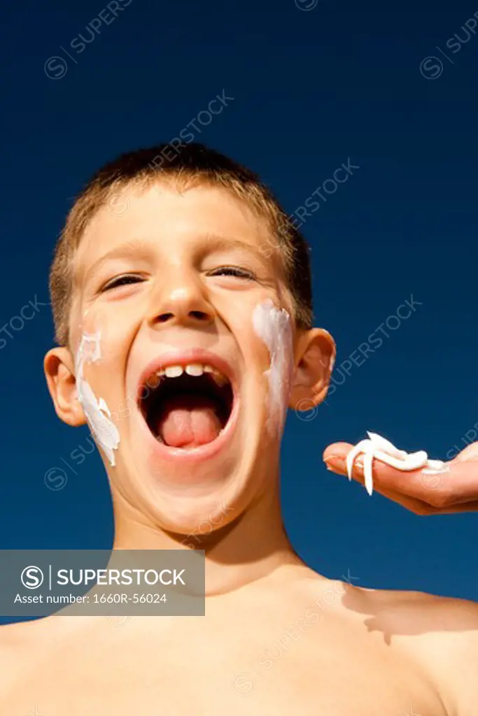 Boy with suntan lotion shouting
