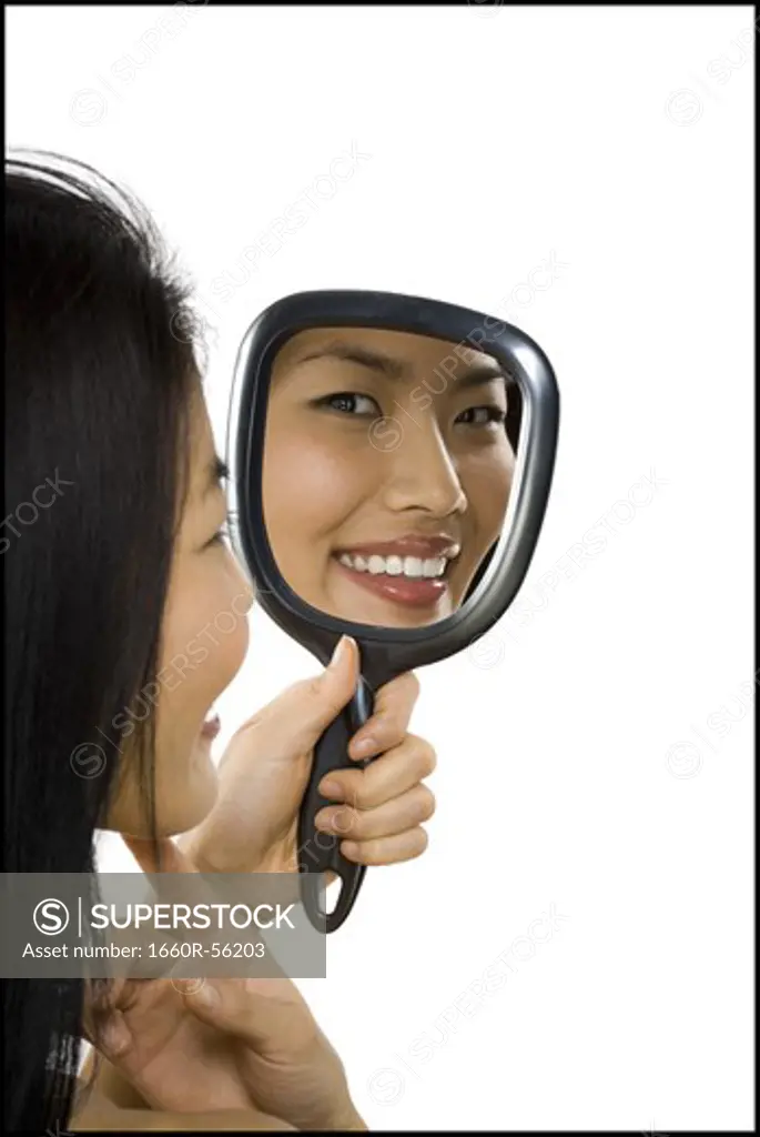 Reflection of woman in hand mirror