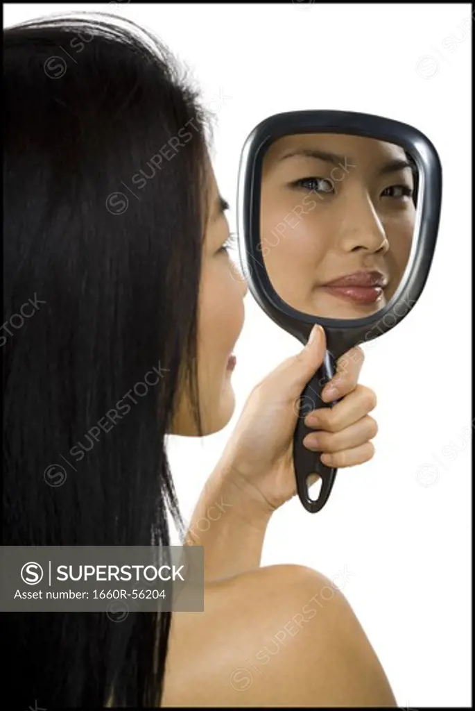 Reflection of woman in hand mirror