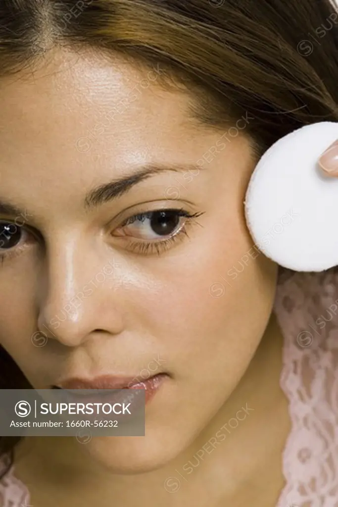 Closeup of woman with powder puff
