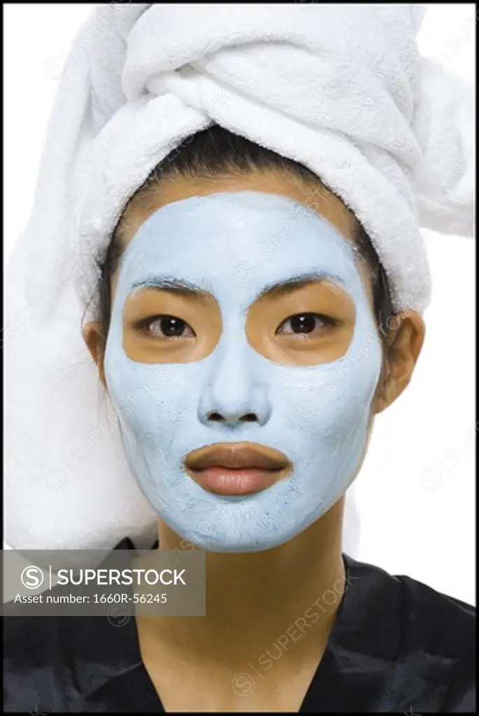 Closeup of woman with facial mask and hair towel