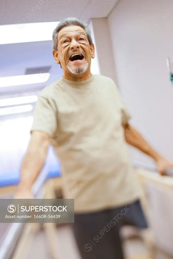 Older man with one leg exercising and smiling
