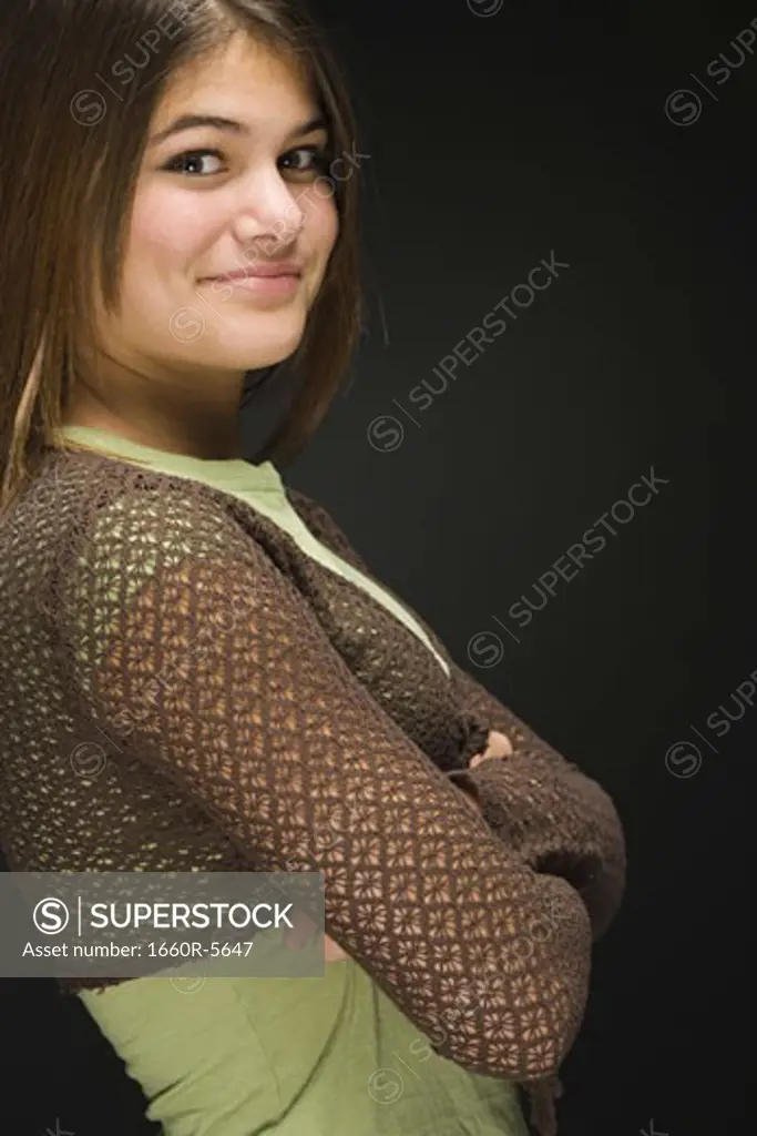Portrait of a teenage girl with arms crossed