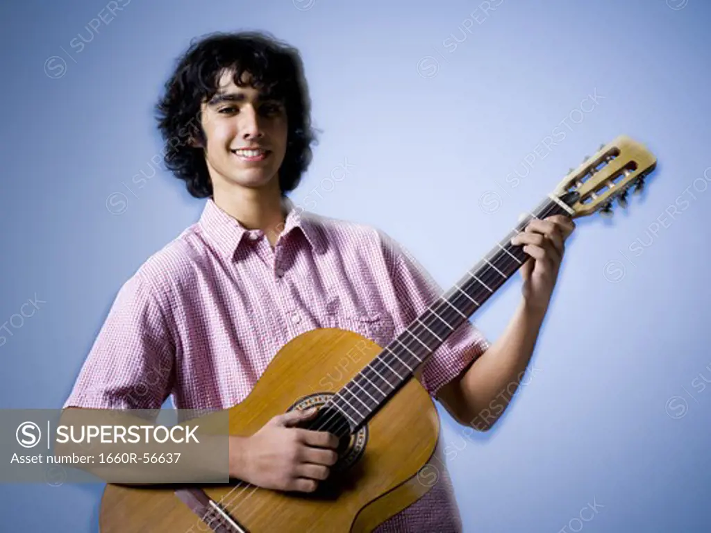 Teenage boy playing guitar