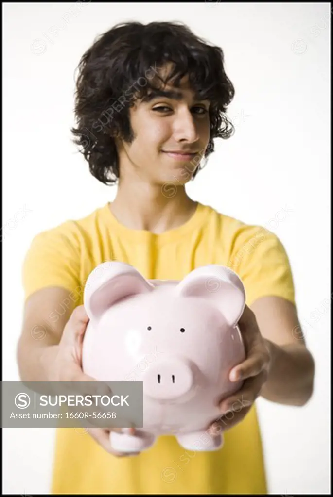 Boy holding a piggy bank