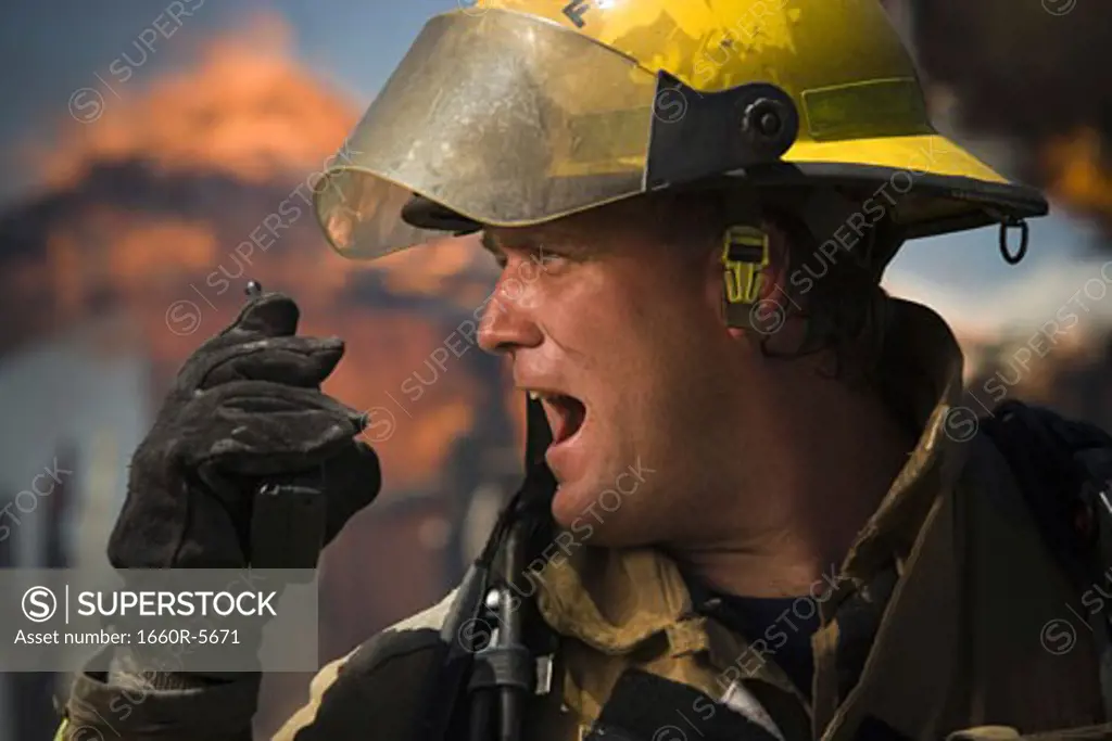 Profile of a firefighter using a walkie-talkie