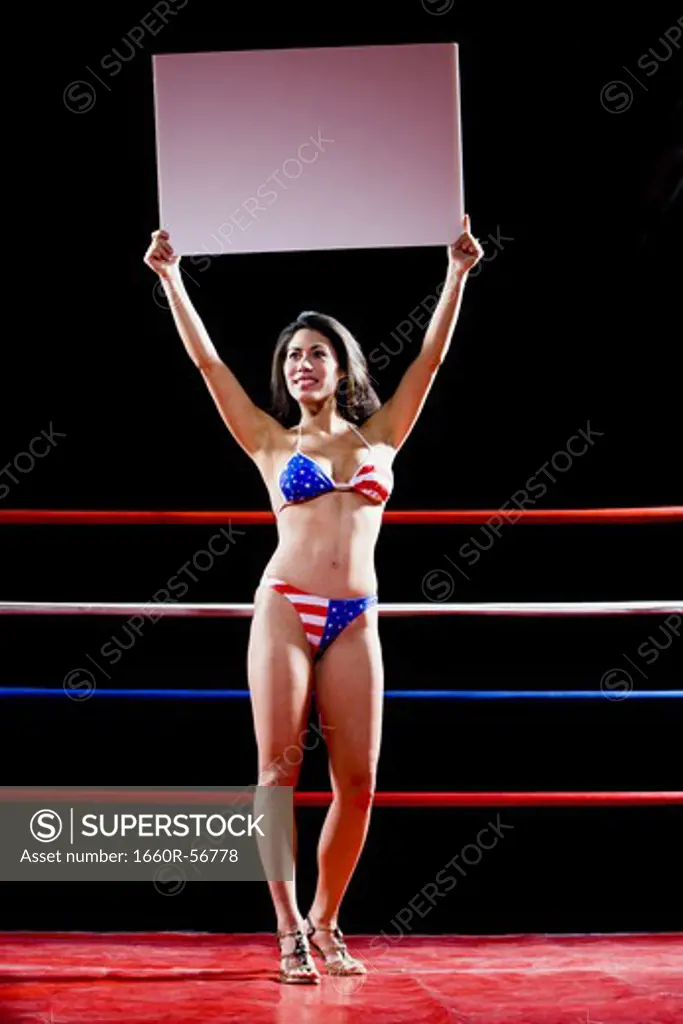 Model with a blank sign in a boxing ring