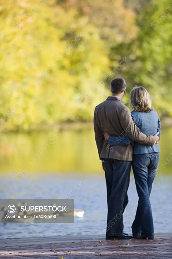 Rear view of a woman and man by a lake