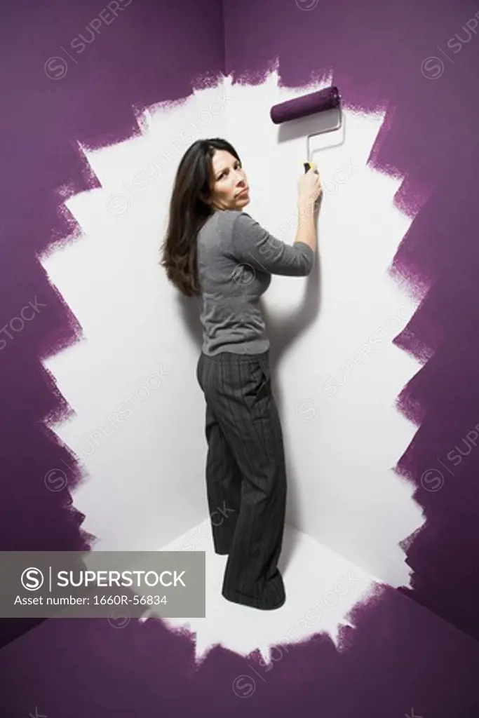 Woman painting herself into a corner