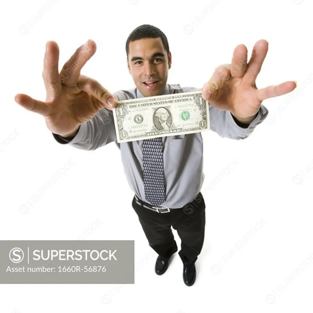 Businessman holding a one dollar bill