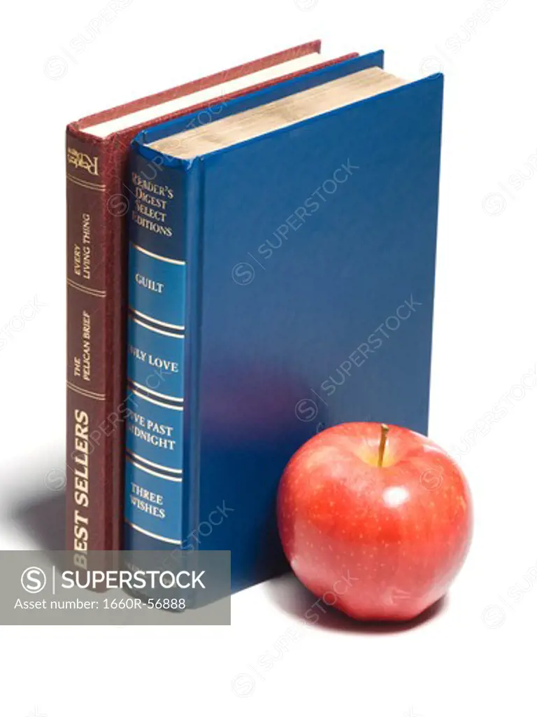Two books with a red apple
