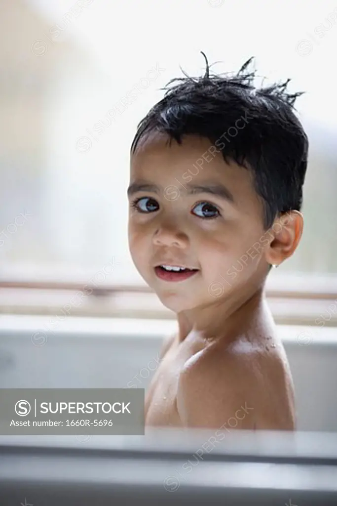 Portrait of a boy in a bathtub