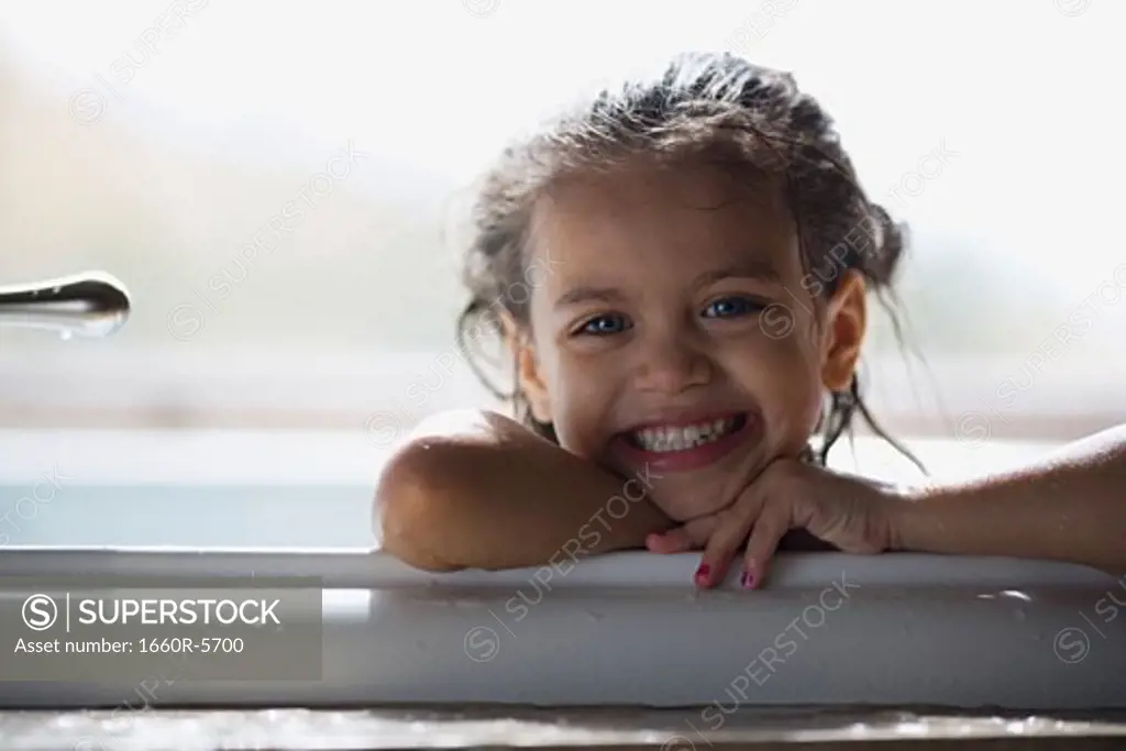 Portrait of a girl smiling in a bathtub